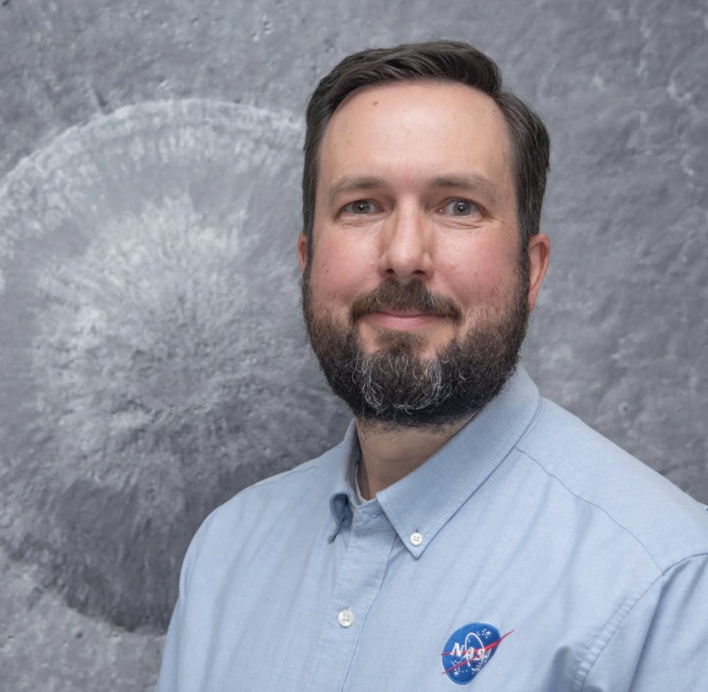A portrait of Noah Petro in a blue NASA shirt.