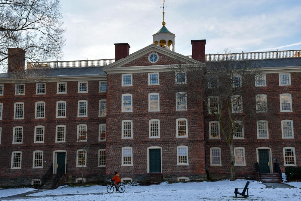 Brown University’s University Hall during the day with snow in front of the building.