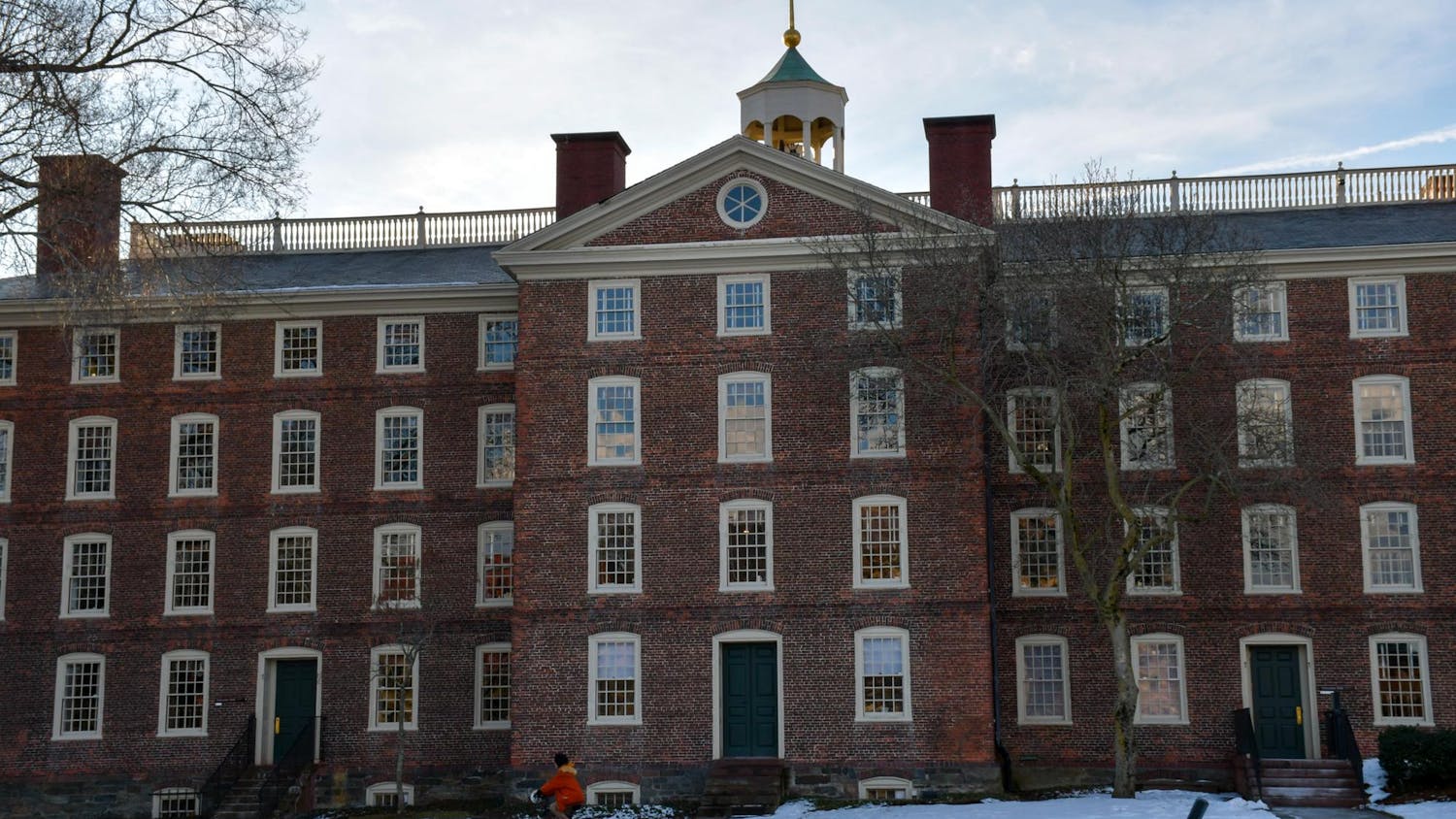 Brown University’s University Hall during the day with snow in front of the building.