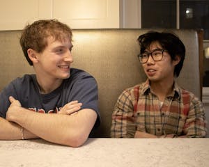 A photo of Nick Clampitt (left) and Keanu (right) sitting in a booth.