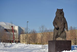 The bear statue in front of the Nelson Fitness Center in the snow.