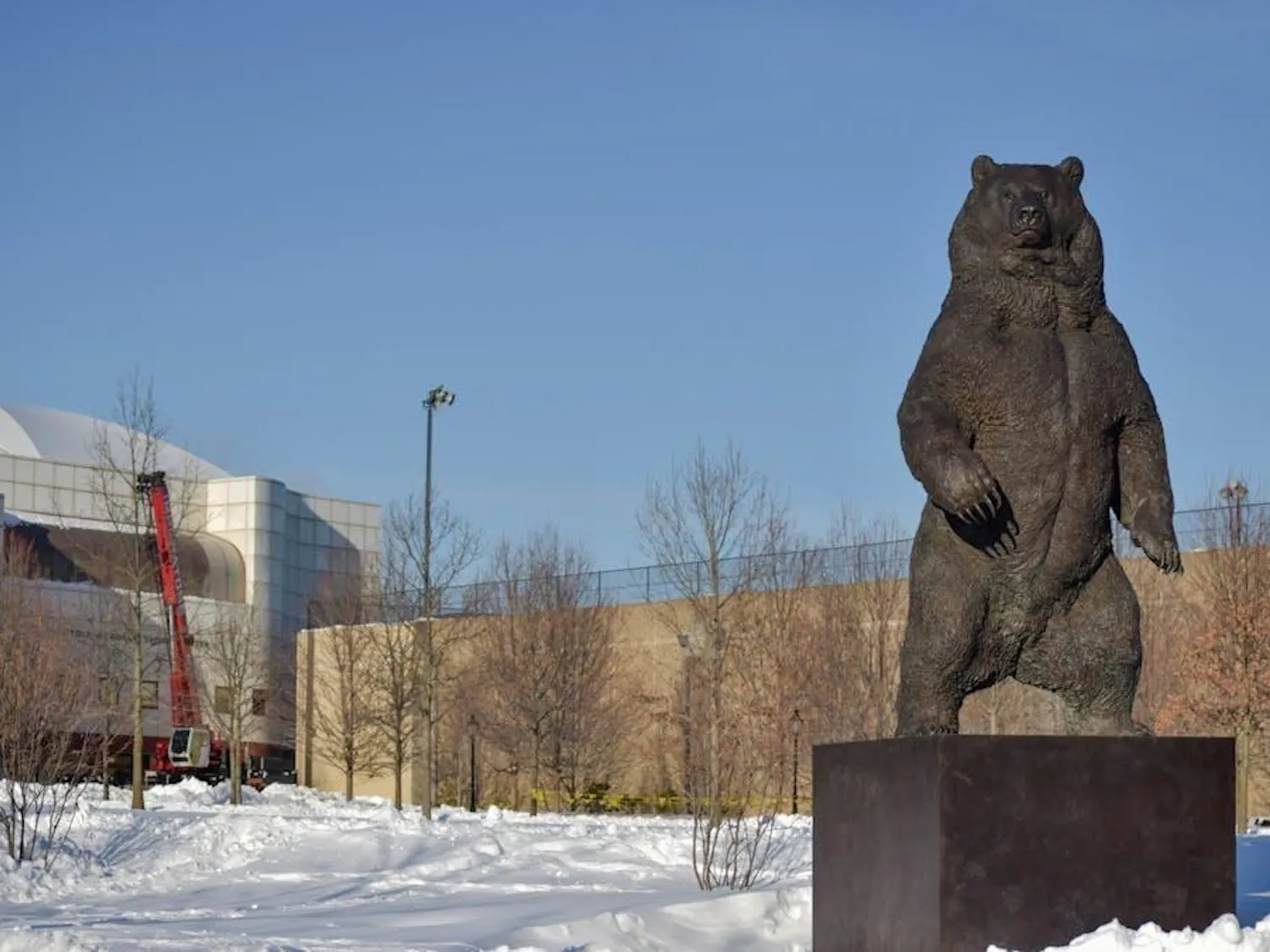 The bear statue in front of the Nelson Fitness Center in the snow.