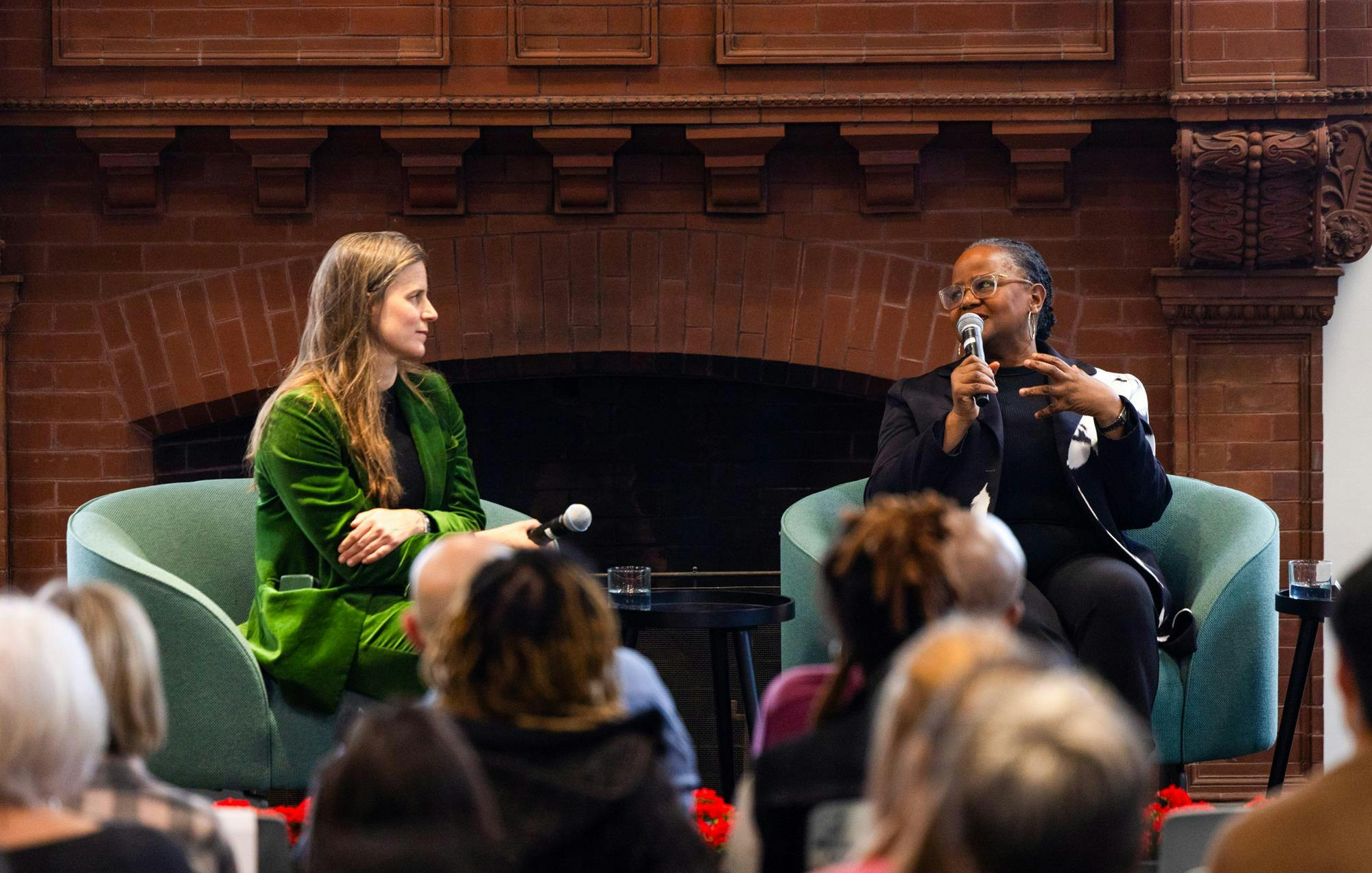 Edwidge Danticat and Lauren Groff sit together and lead a lecture, speaking towards a seated group of people. 