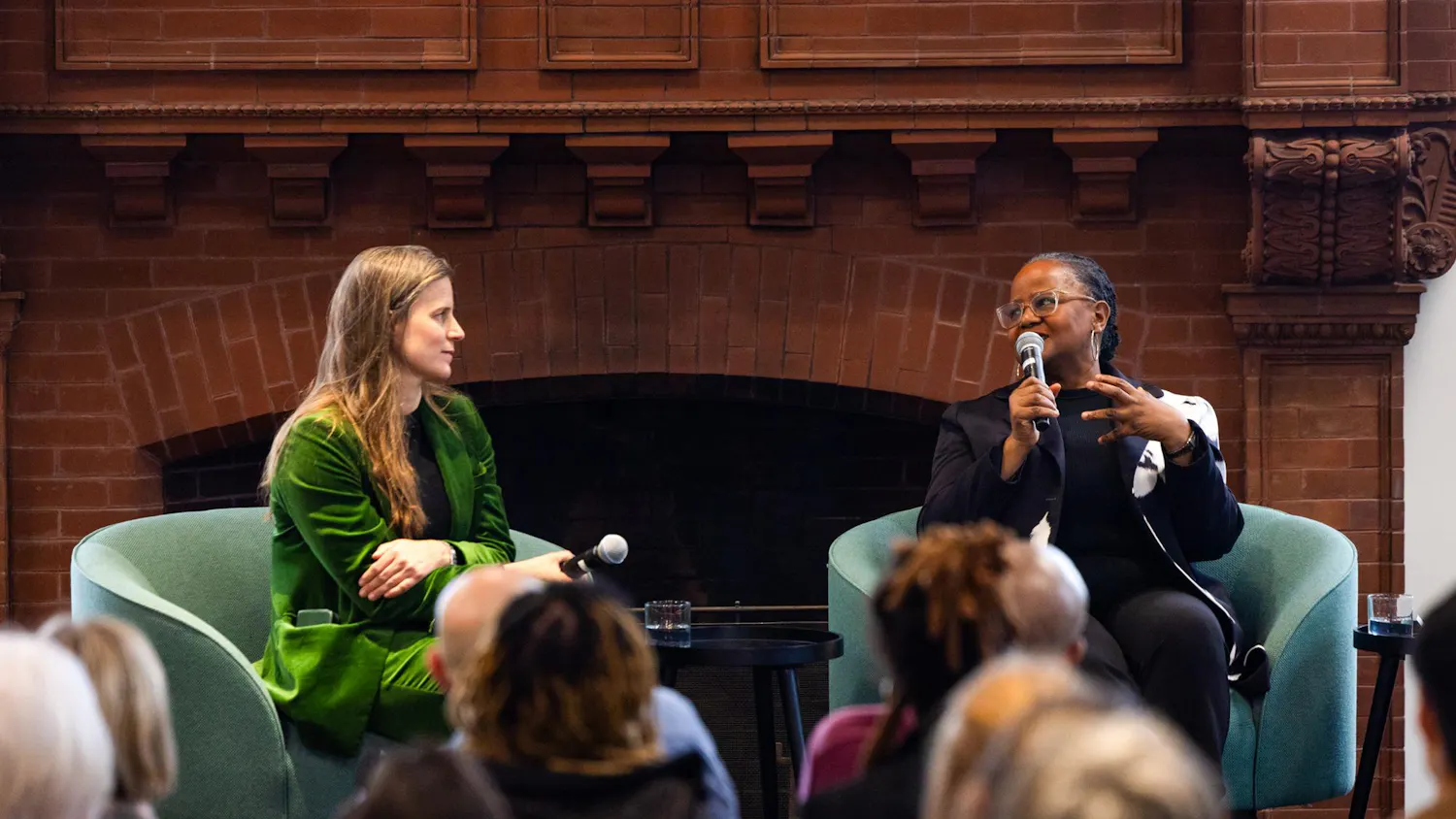 Edwidge Danticat and Lauren Groff sit together and lead a lecture, speaking towards a seated group of people.