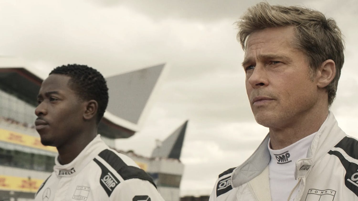 Still from “F1” showing Sonny Hayes (right), played by Brad Pitt, and Joshua Pearce (left), played by Damson Idris.