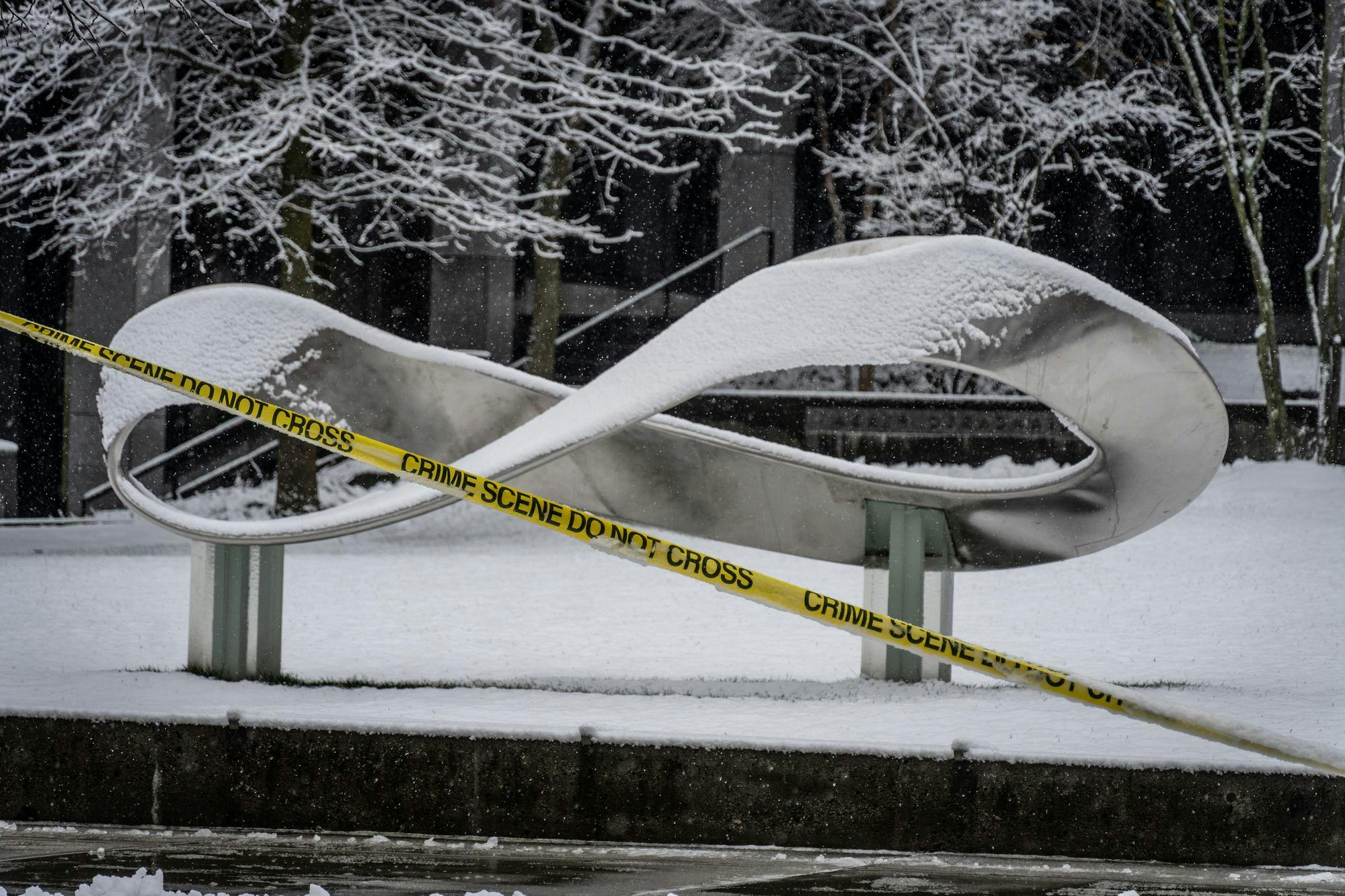 Photo of the infinity statue in front of Barus and Holley with caution tape in front of it.