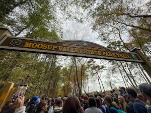Photo filled with participants under the gate of the Moosup Valley State Park Trail, starting point for the walk.