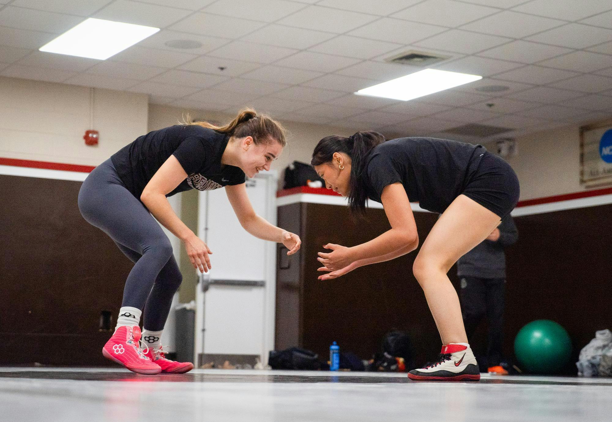 Two wrestlers, Calli Gilchrist ’29 (left) and Annie Ye ’26 (right), sparring at wrestling practice