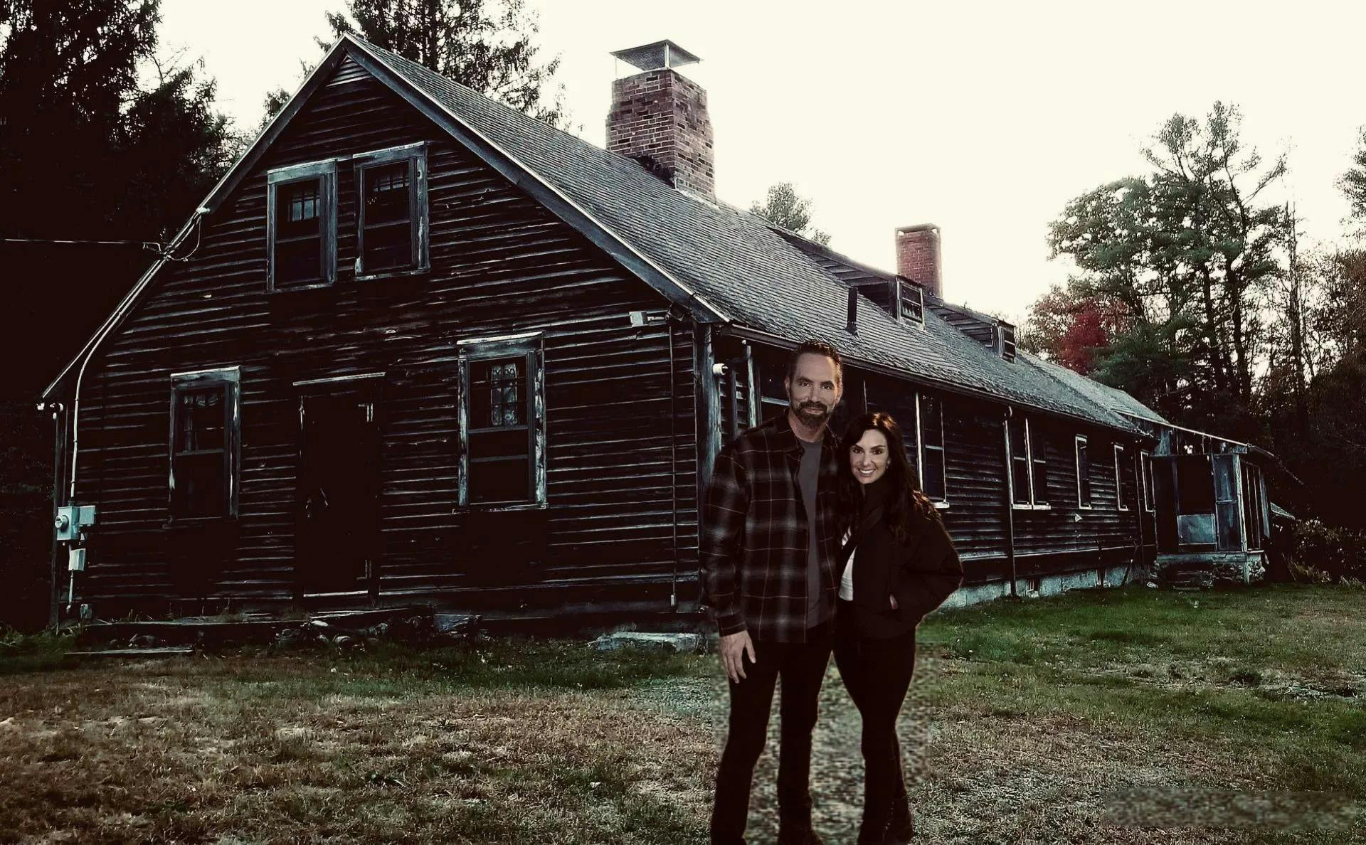Tessa Groff and Nick Groff standing in front of the Conjuring House