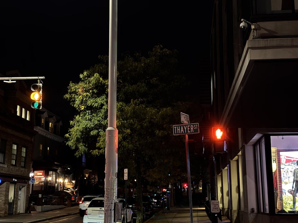 Photo of the intersection of Thayer and Angell streets at night.