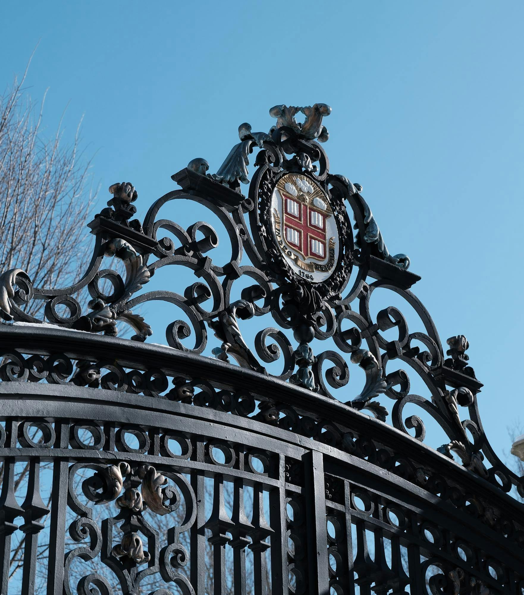 Photo of the top of the Van Wickle Gates, showing the Brown insignia and black metal bars.