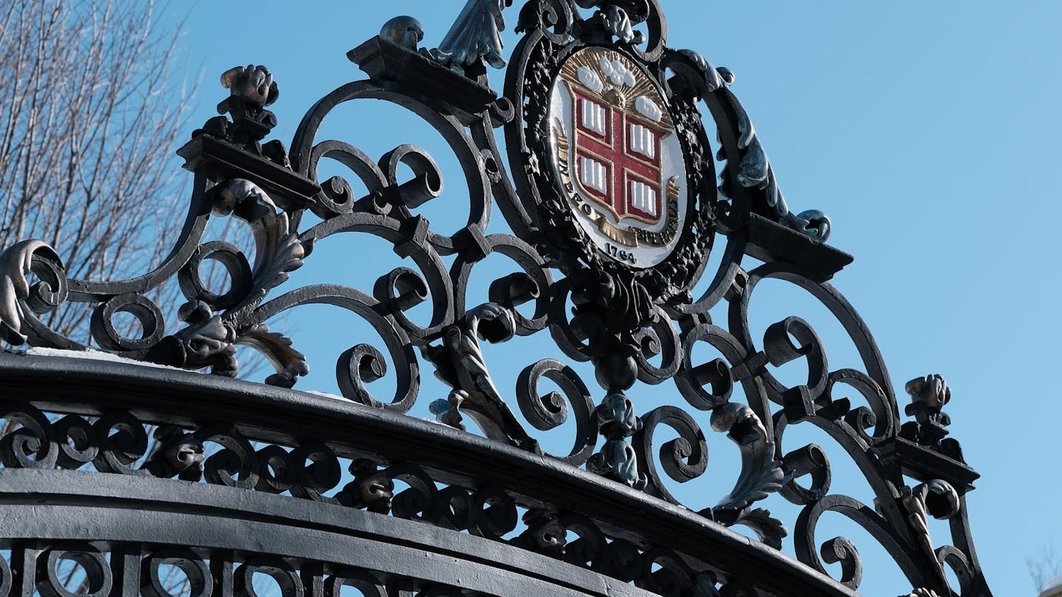 Photo of the top of the Van Wickle Gates, showing the Brown insignia and black metal bars.
