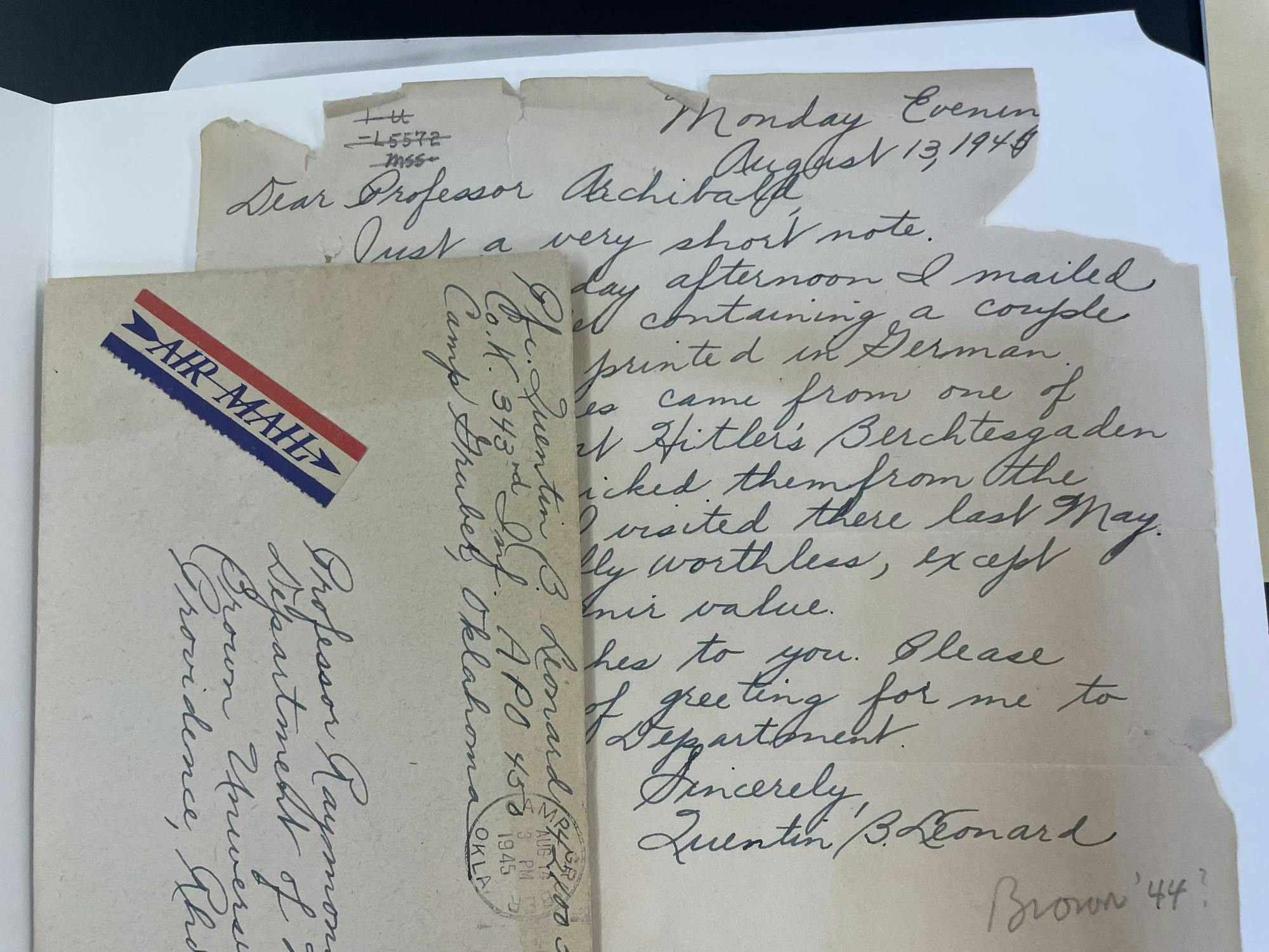 There is a vertical envelope laid on top of the letter from Quentin B. Leonard’s ‘44 to Professor Raymond Archibald about the magazines he'd collected from Hitler's residence.