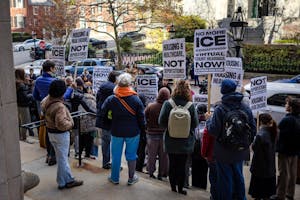 The backs of protestors at a protest with signs reading "NO MORE ICE KIDNAPPINGS"