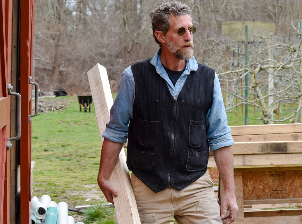 Patrick Bowen, president of the Little Compton Housing Trust, moving materials for a barn being converted into a farmers’ market.
