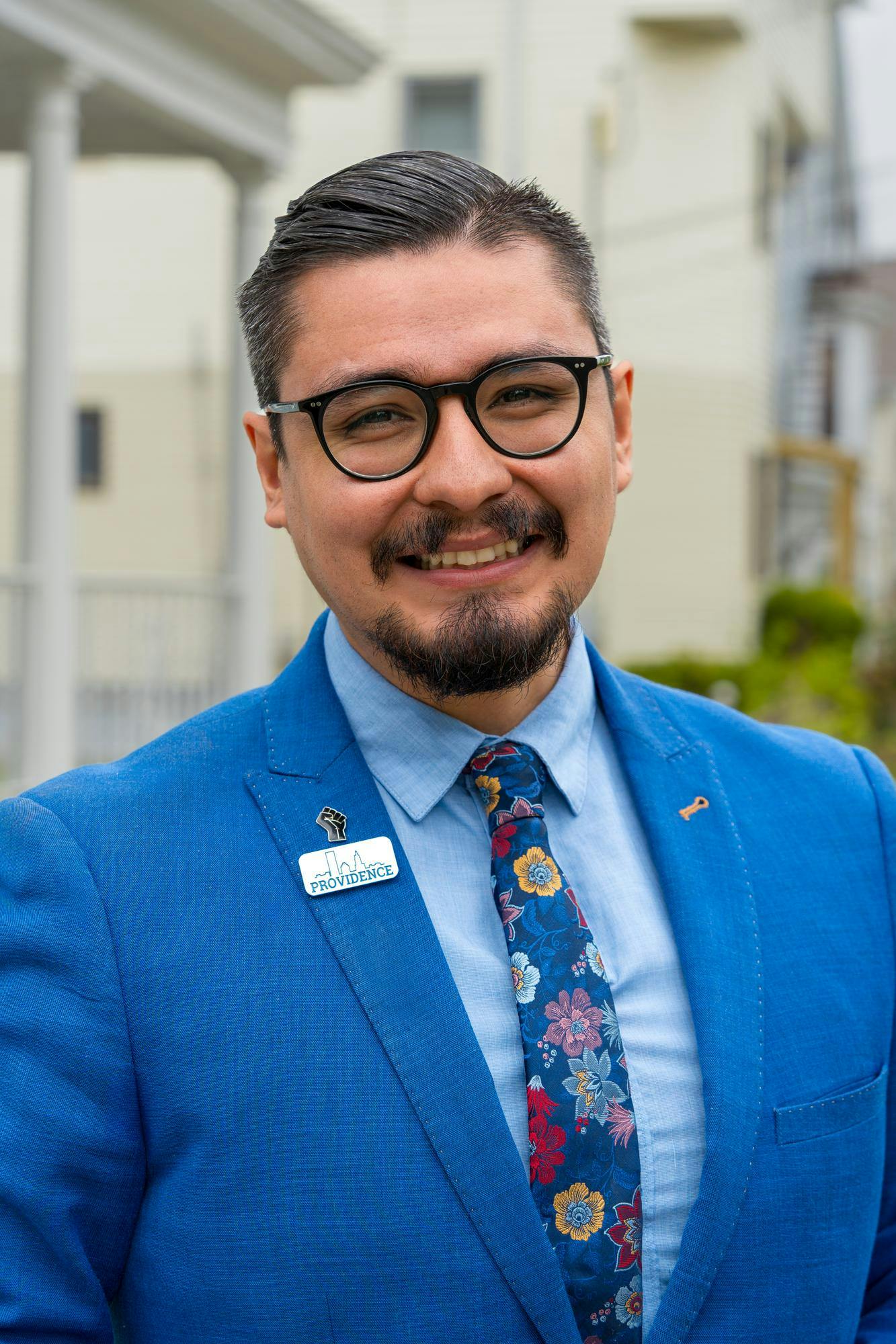 Photo of David Morales in a blue suit