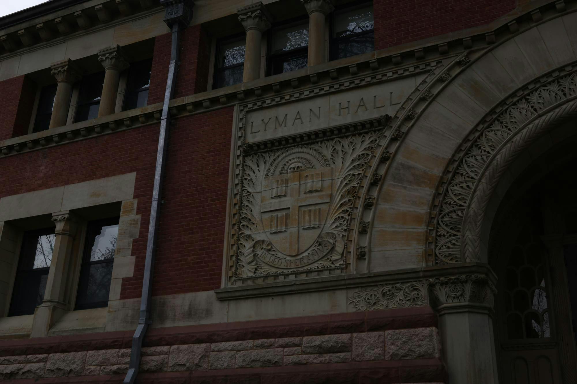 A picture of a stone detail on Lyman Hall, which depicts Brown's crest, with the words Lyman Hall above it.