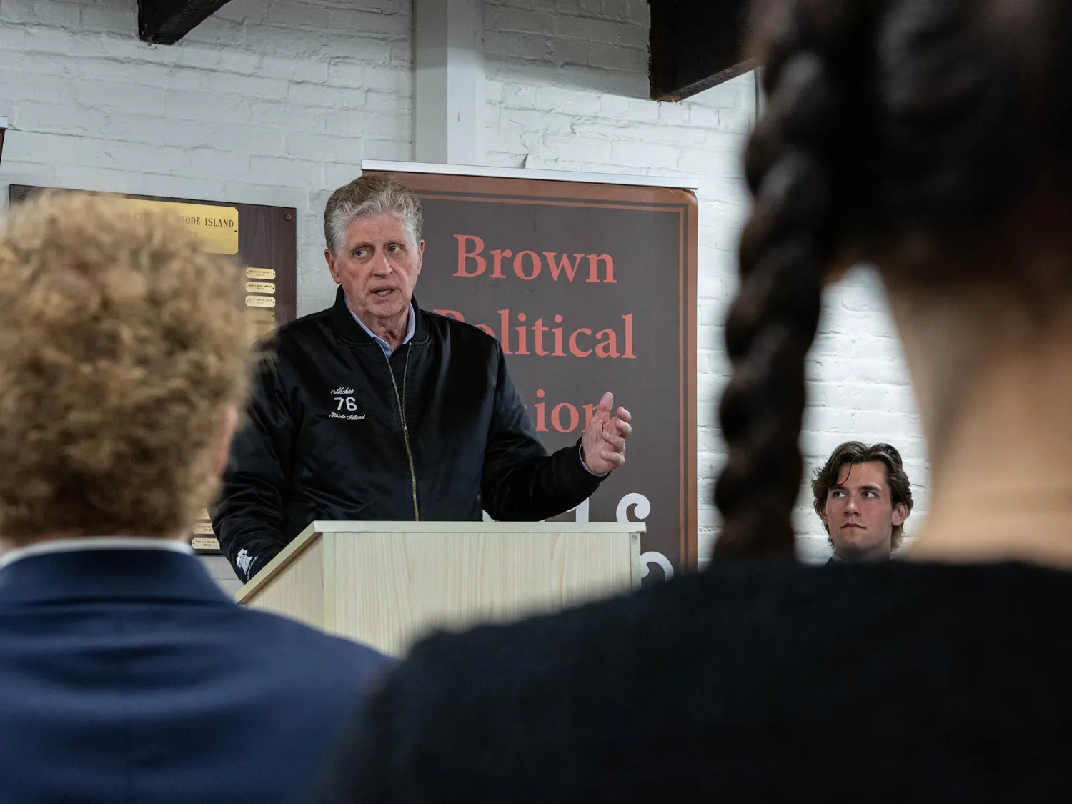A photo depicts McKee giving a speech to attendees of the event.