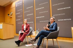 LeVine (left) and Nuland (right) sit side by side. Nuland speaks with a microphone.