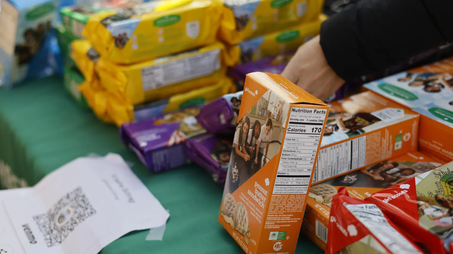 Photo of boxes of girl scout cookies on a table.