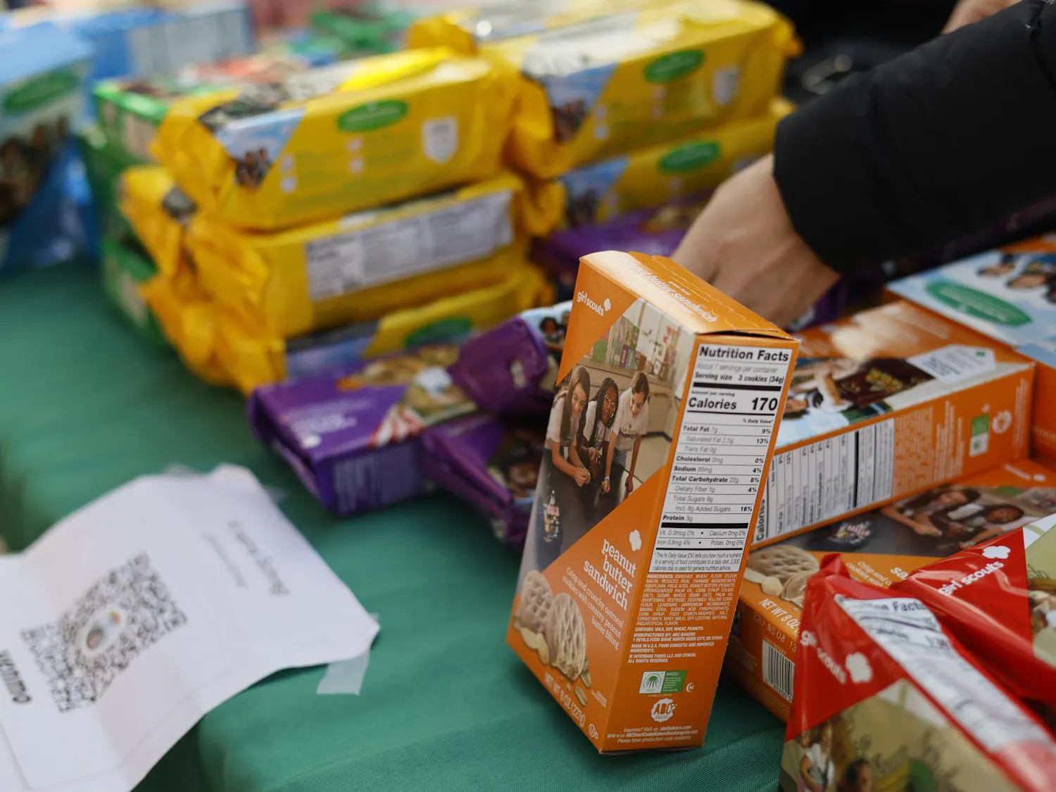 Photo of boxes of girl scout cookies on a table.