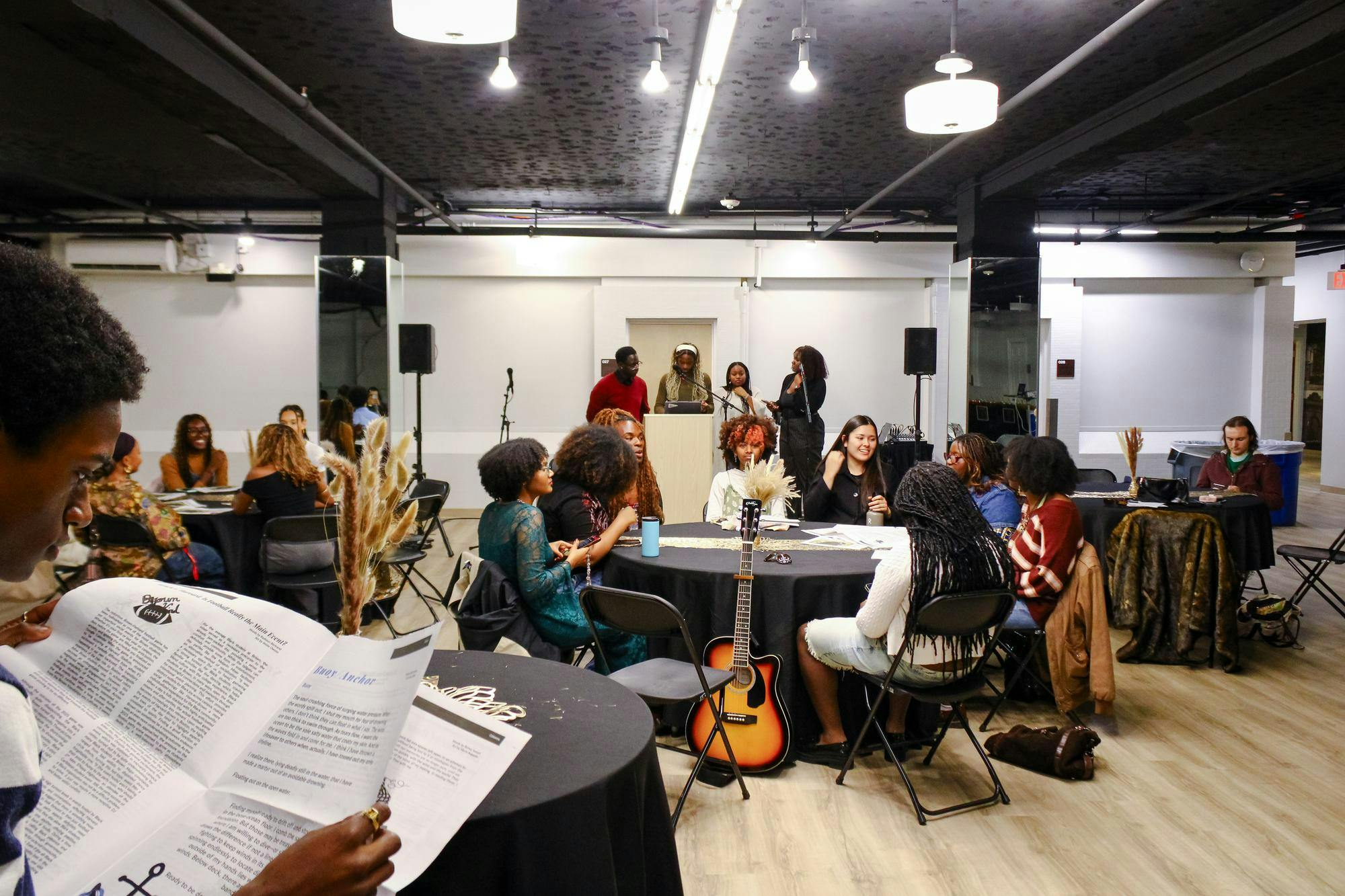 Attendees sitting around tables at the Black Arts Expo