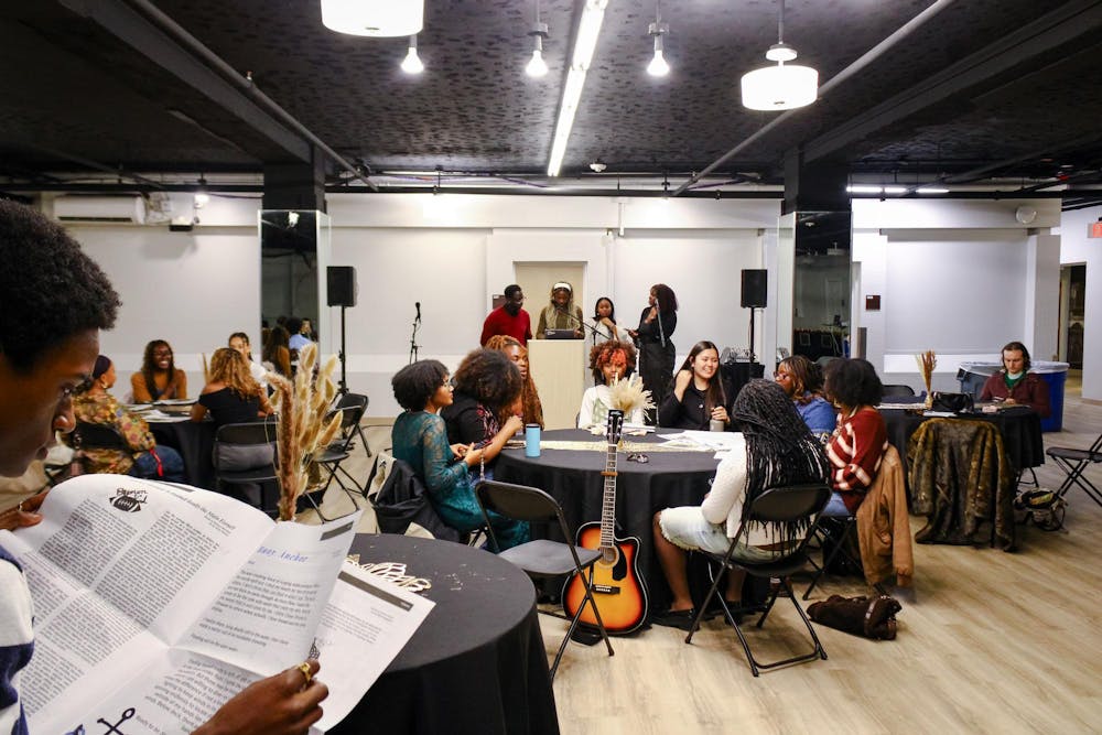 Attendees sitting around tables at the Black Arts Expo