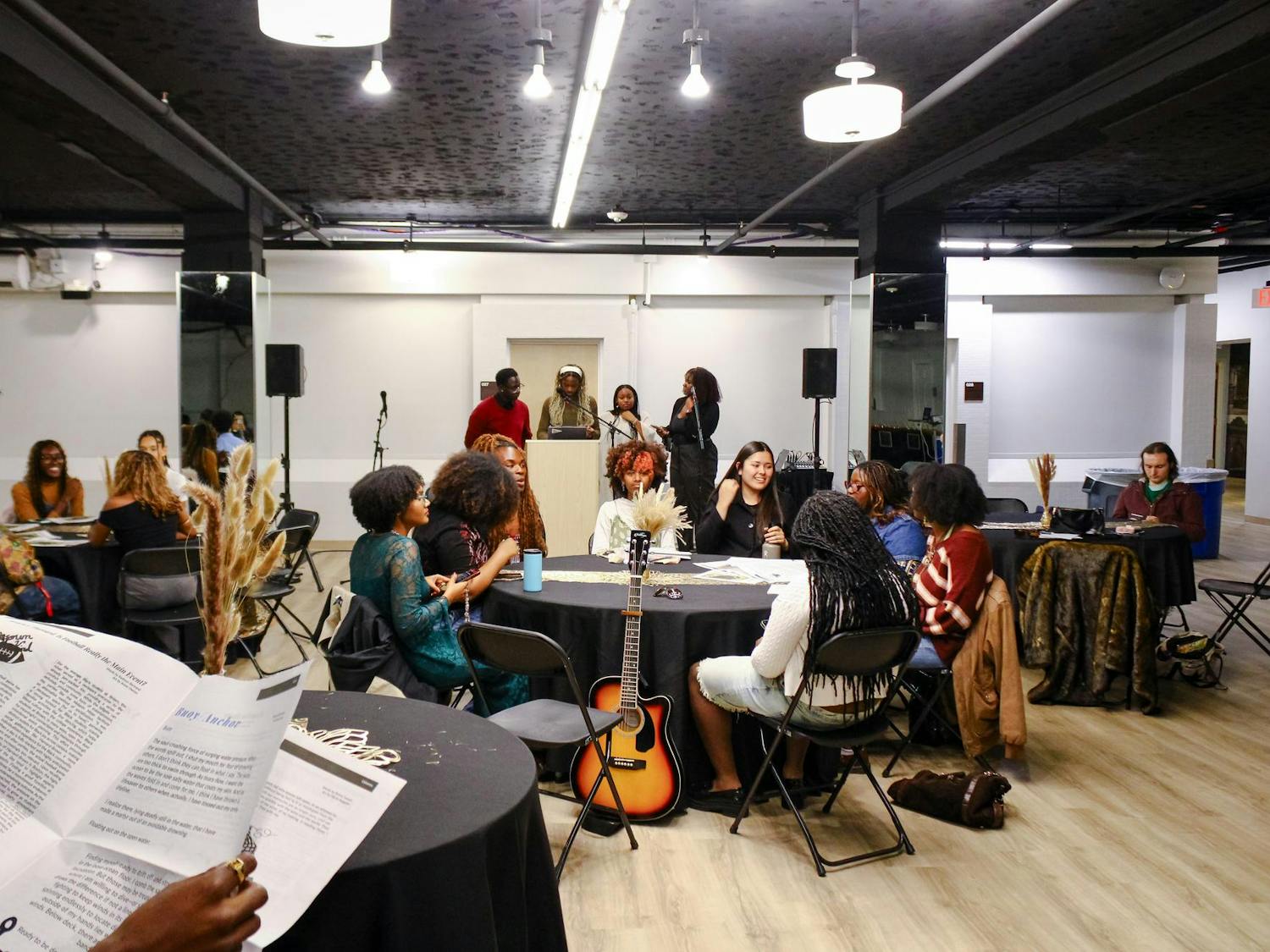 Attendees sitting around tables at the Black Arts Expo
