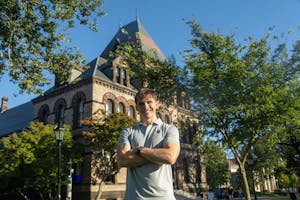 Photo of Blaine Maye in front of Sayles Hall
