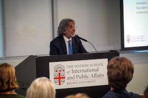Photo of a man in a suit giving a speech at a podium.