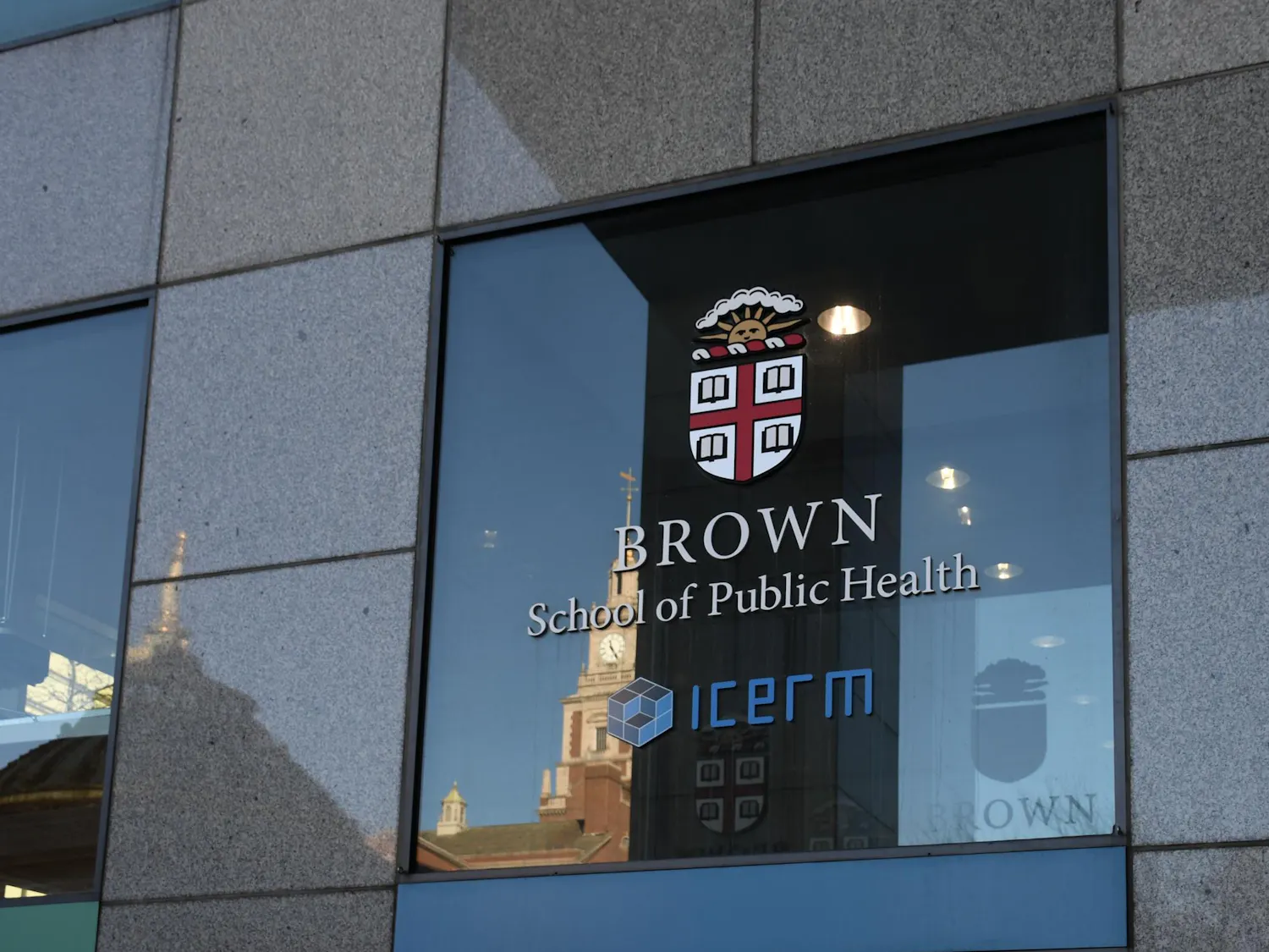 Photo of the outside of the School of Public Health featuring the Brown University insignia.