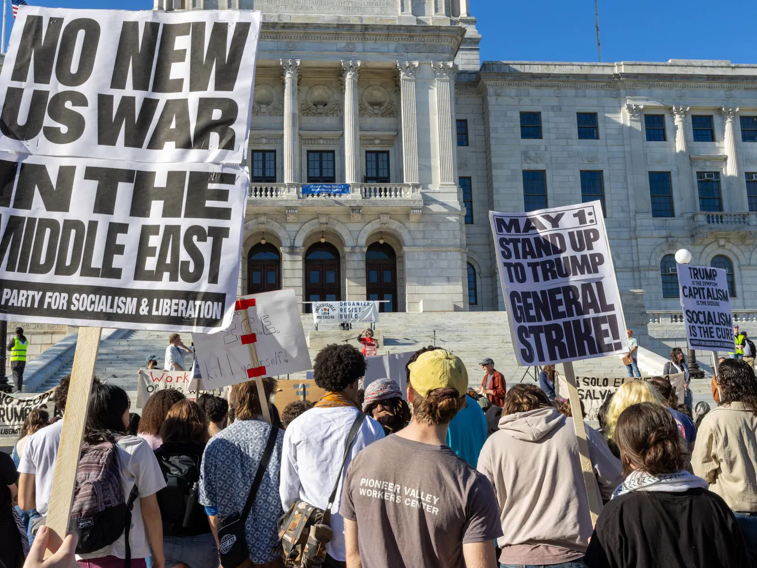 Photo of protestors holding signs opposing war in the Middle East in front of the Rhode Island State House.