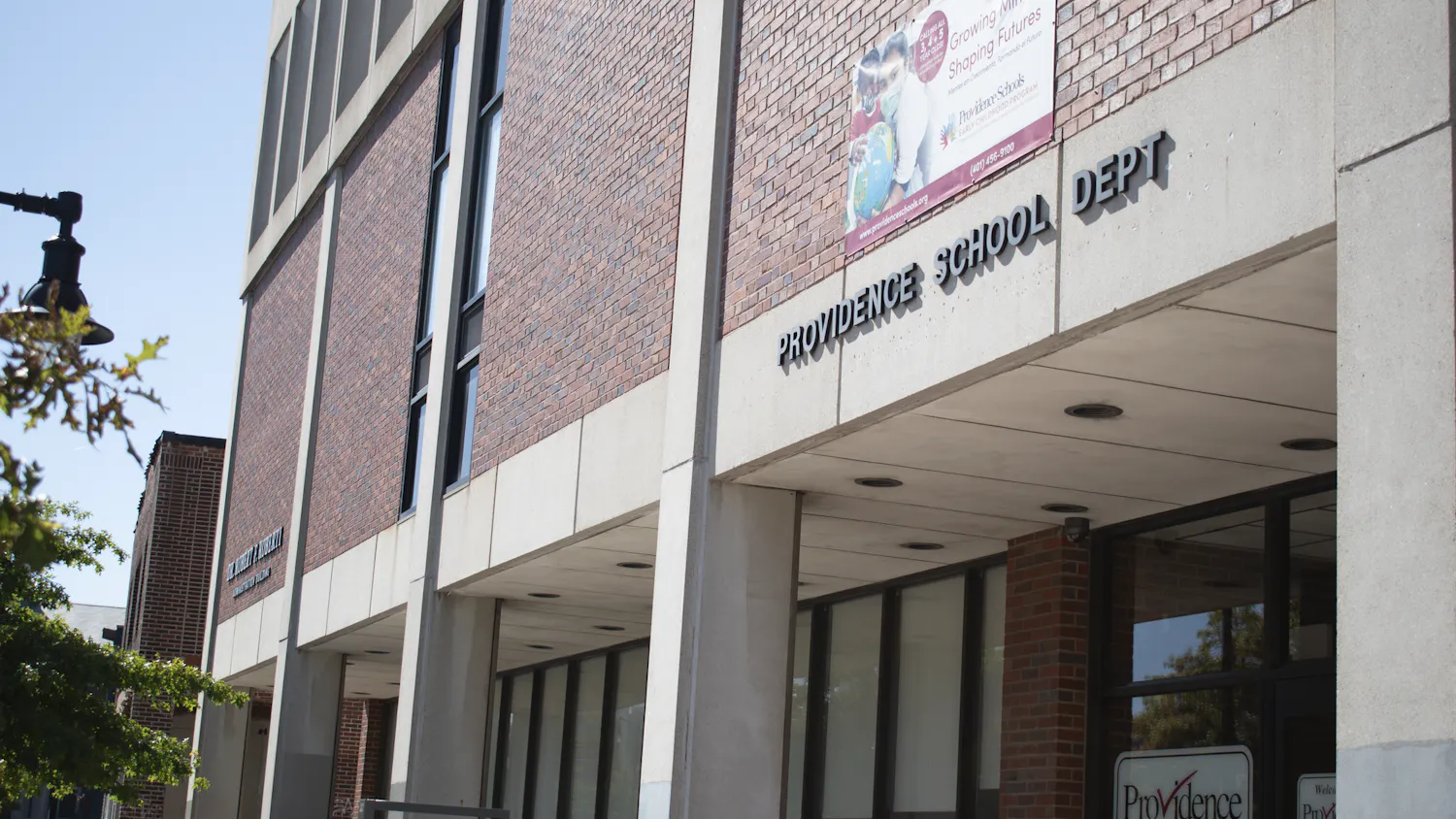 Slanted angle of a brick building that reads, Providence School Dept.