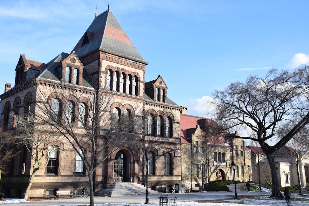 Sayles Hall, on Brown's campus, stands in the sunlight against the blue sky. 
