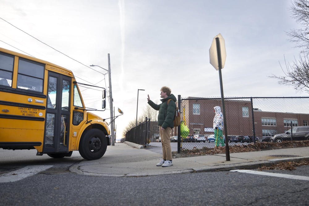 Photo of Daniel Solomon waving to a school bus