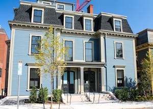 Photo of a large, light-blue building.

