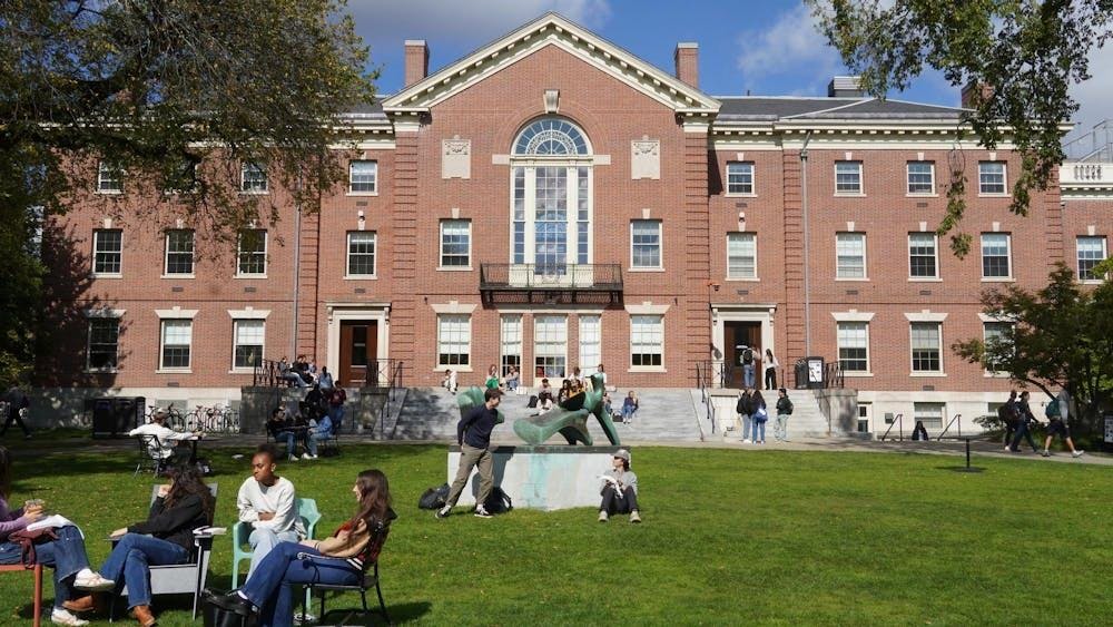 Brown University students study and relax on Brown University's Main Green in front of the Stephen Robert '62 Campus Center. 