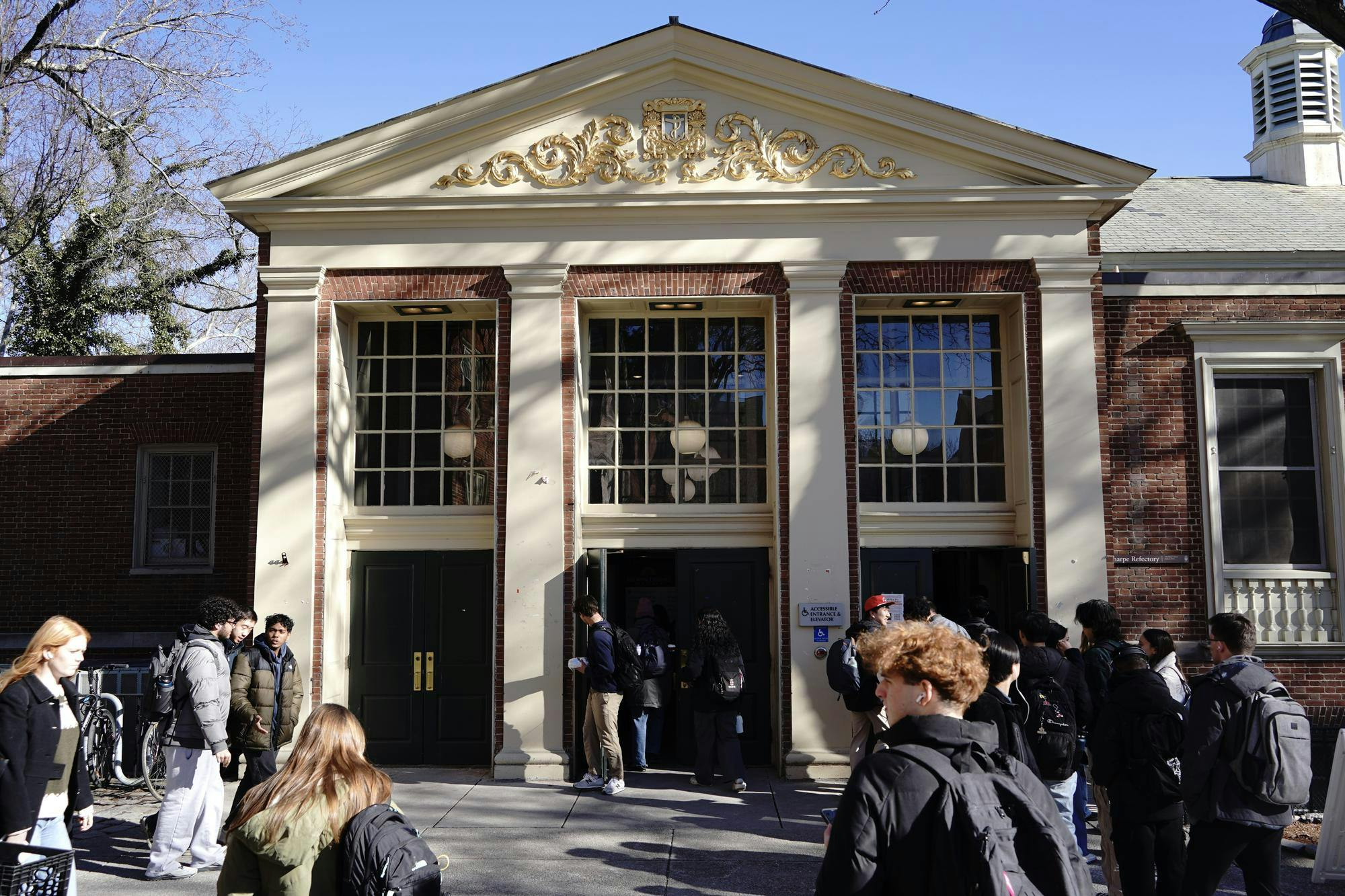 Photo of the front of the Ratty as students walk in and out the building. 
