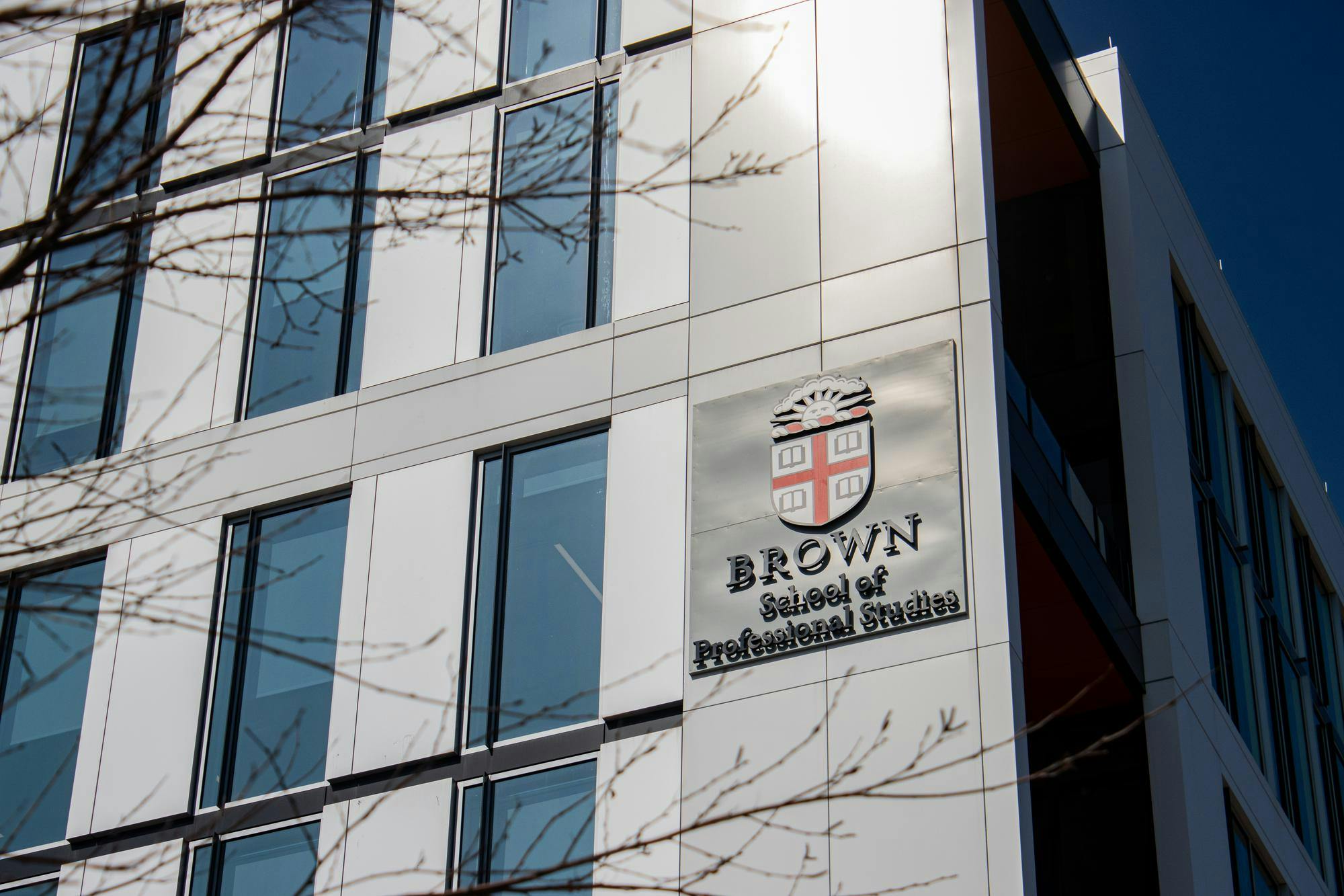 Photo of the outside of the School of Professional Studies featuring the Brown Insignia.