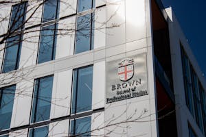 Photo of the outside of the School of Professional Studies featuring the Brown Insignia.