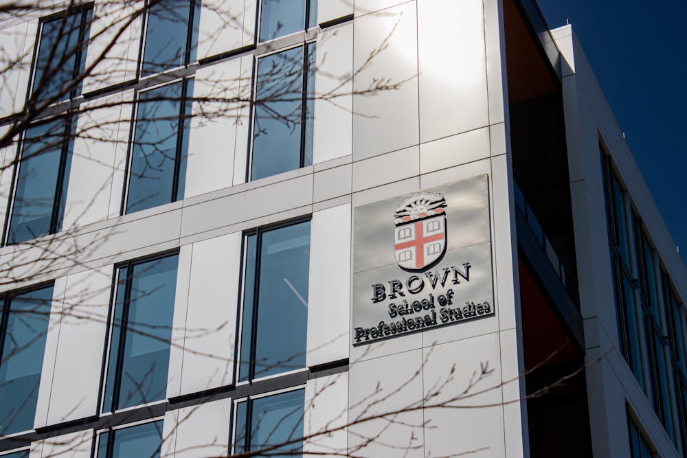 Photo of the outside of the School of Professional Studies featuring the Brown Insignia.