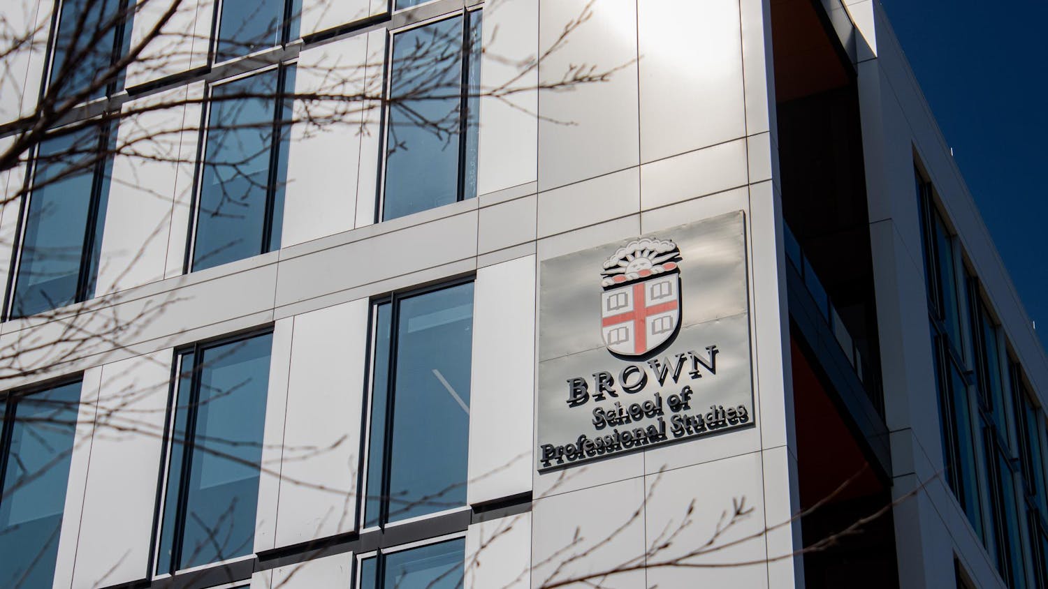 Photo of the outside of the School of Professional Studies featuring the Brown Insignia.