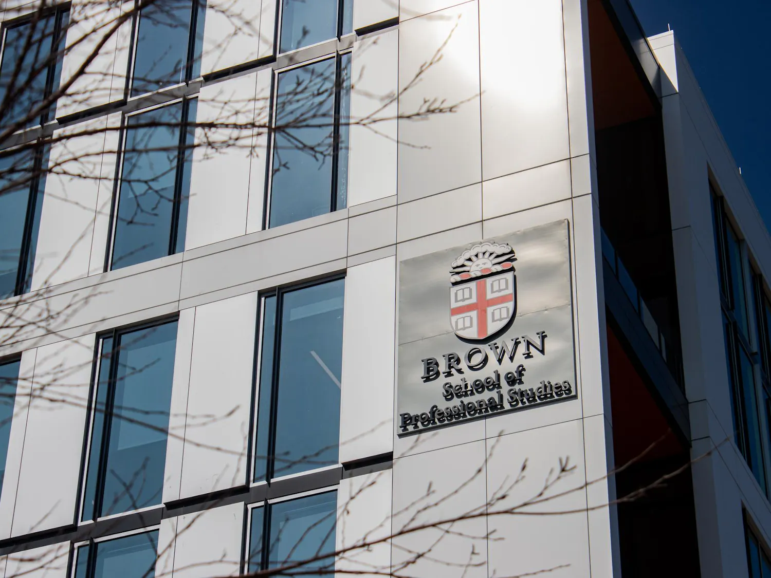 Photo of the outside of the School of Professional Studies featuring the Brown Insignia.