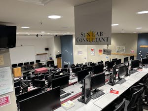 In the empty Sun Lab, descending rows of desktop computers face a white board.