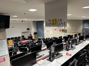 In the empty Sun Lab, descending rows of desktop computers face a white board.  