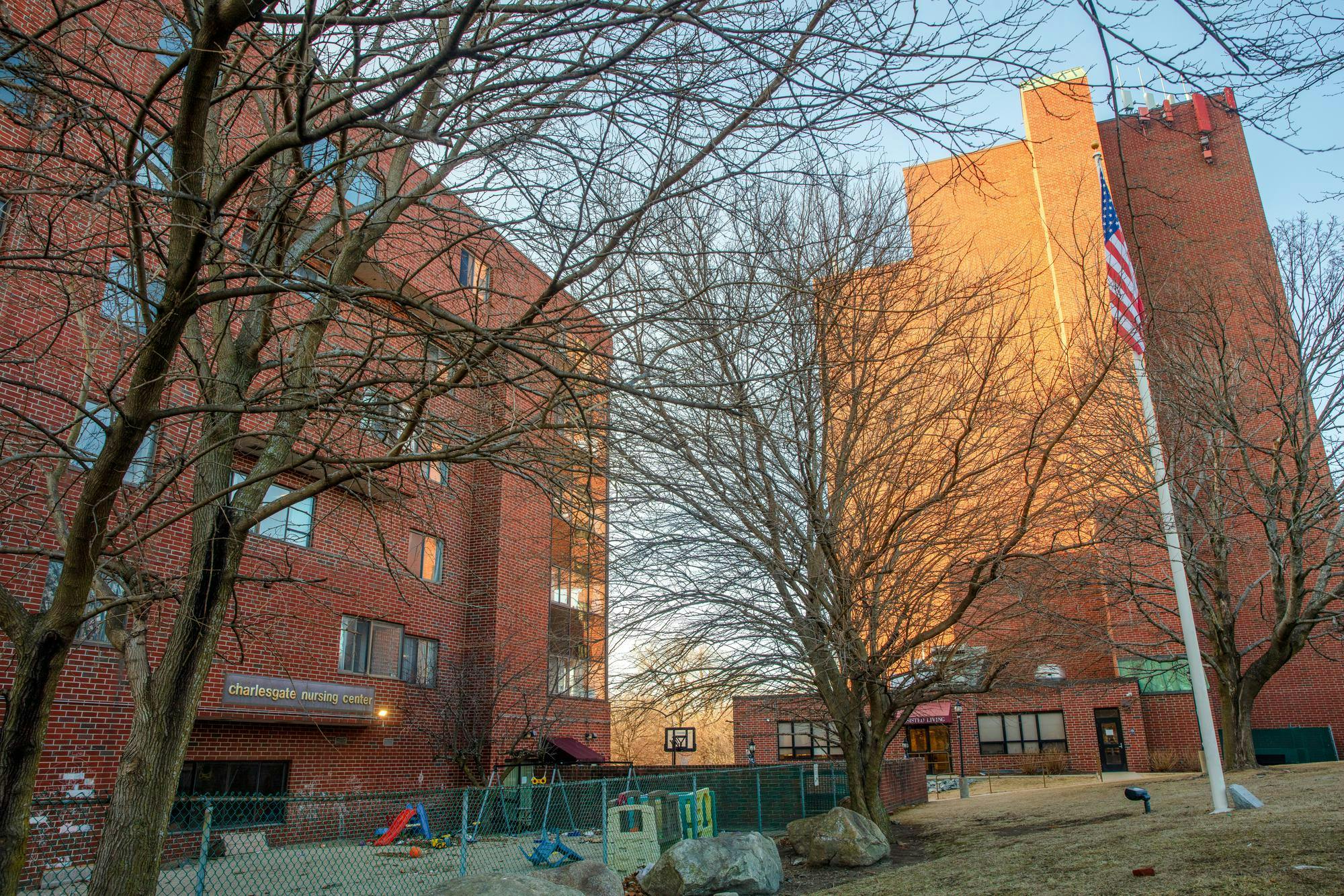 An image of the Charlesgate Nursing Center, a brutalist brick building, on a sunny winter/fall day.