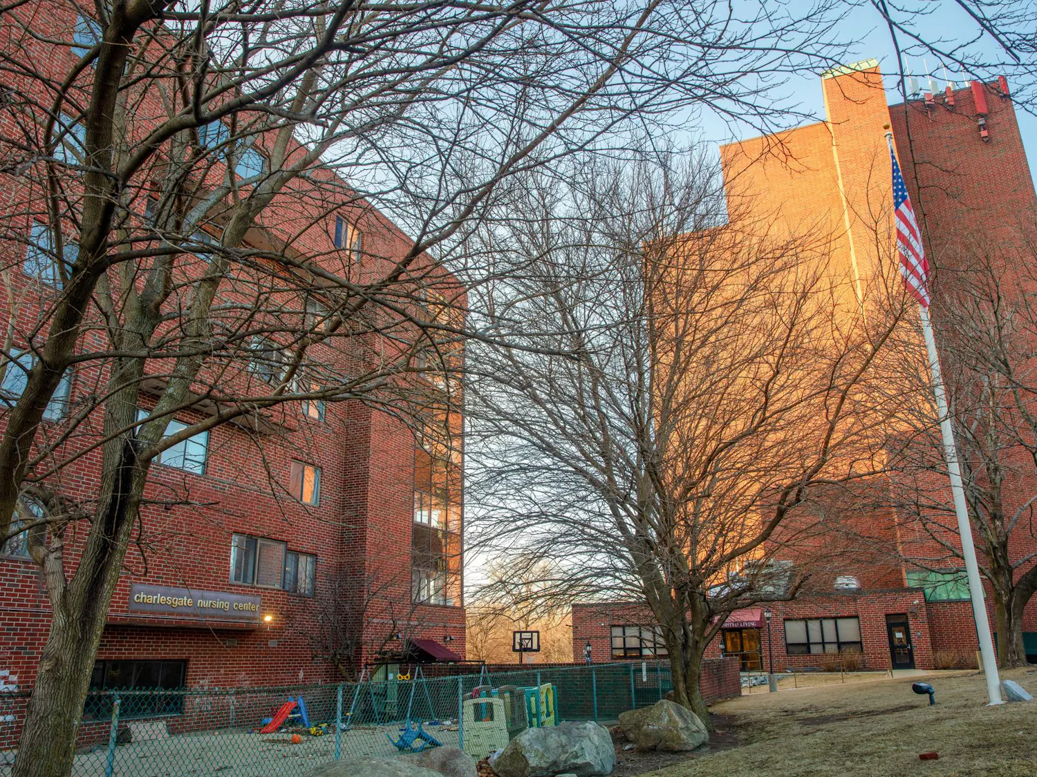 An image of the Charlesgate Nursing Center, a brutalist brick building, on a sunny winter/fall day.
