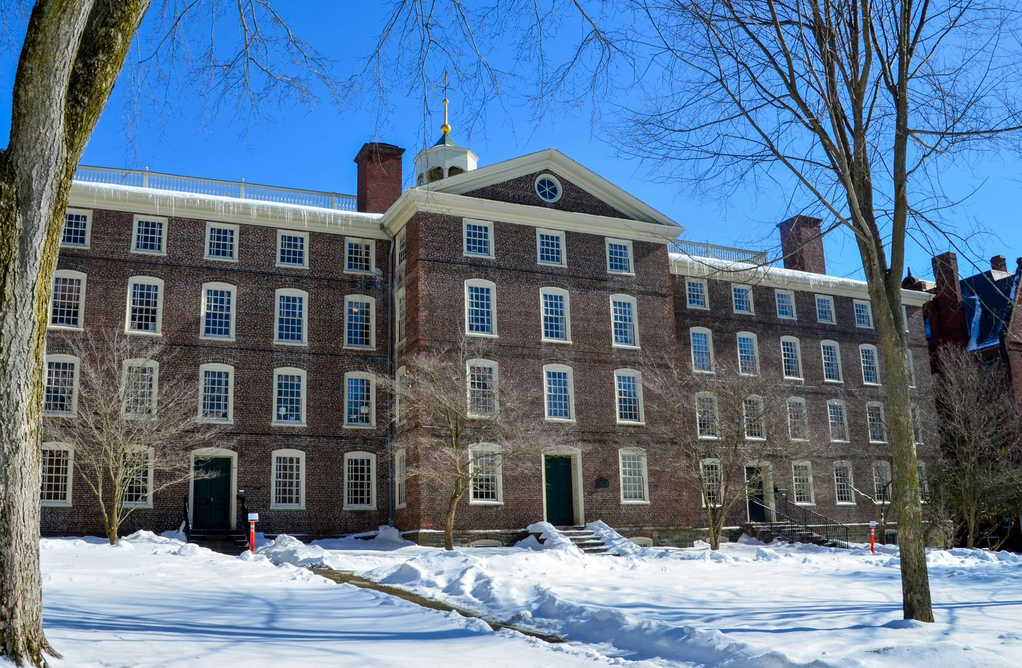 Photo of University Hall during a sunny day with clear skies and snow on the ground.