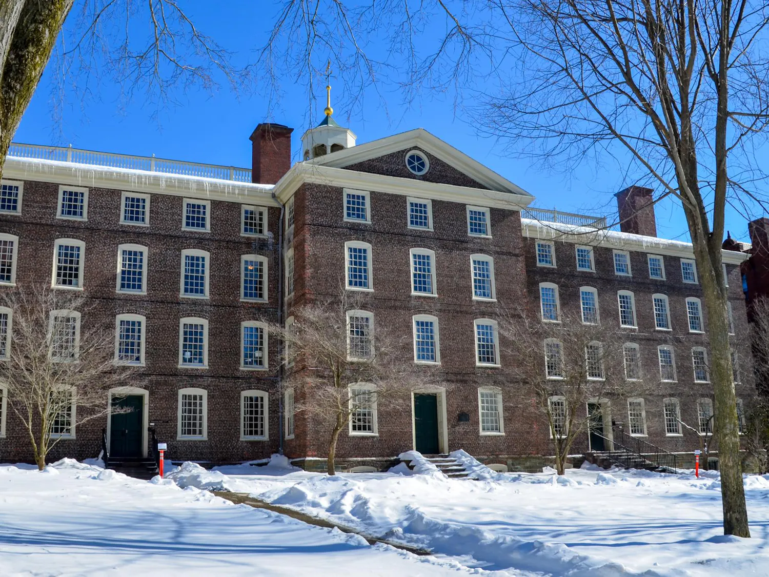 Photo of University Hall during a sunny day with clear skies and snow on the ground.