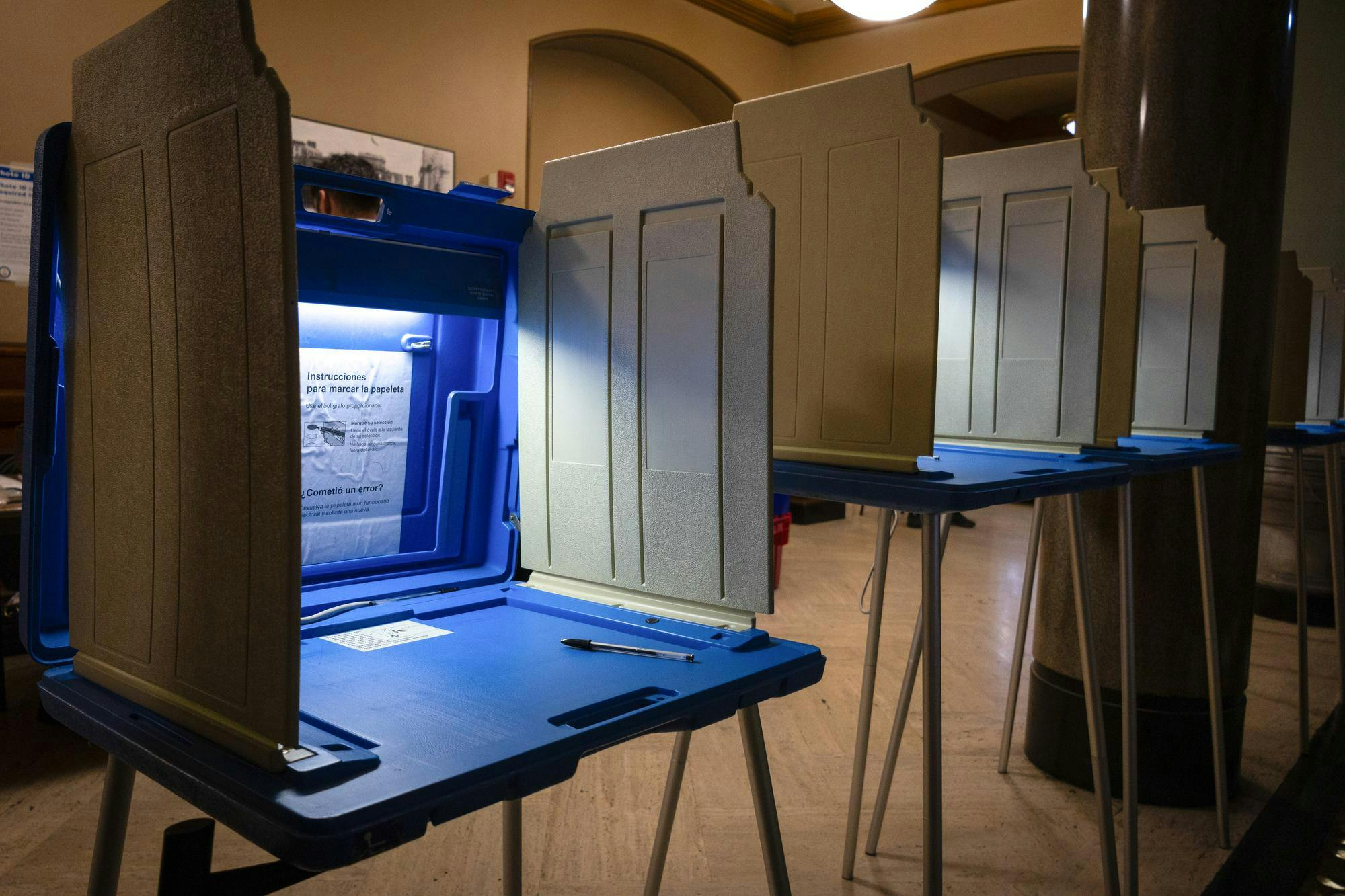 A photo of a line of blue Rhode Island voting booths.